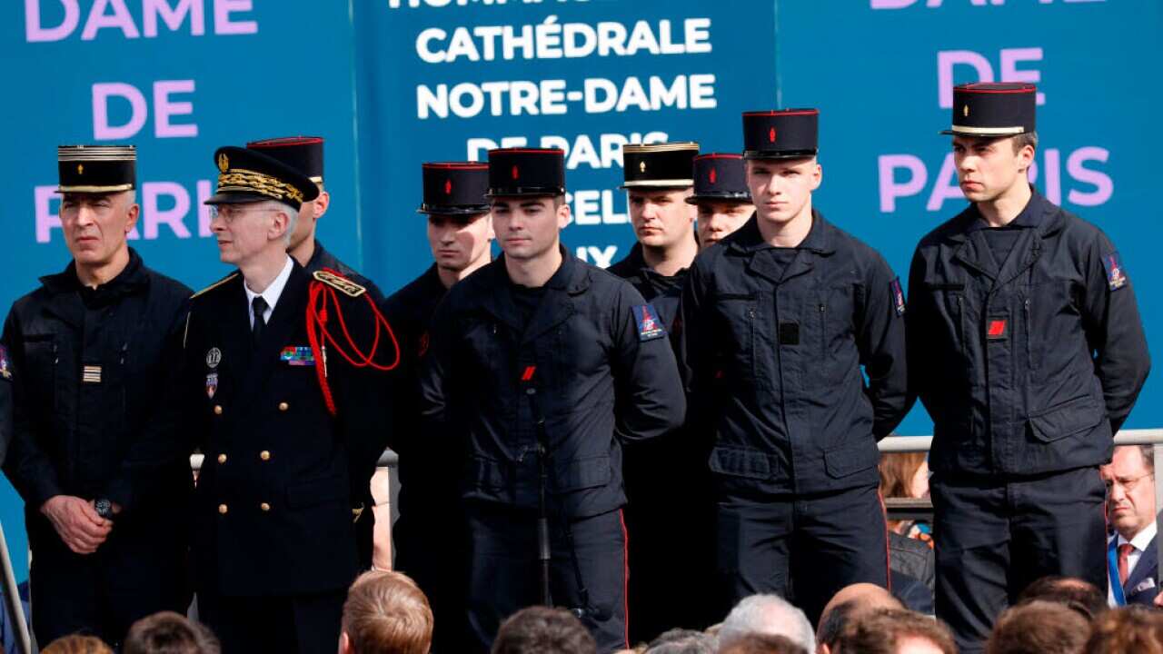 Members of the fire brigade stand as on the stage as on the forecourt of the City Hall for a tribute to those who have helped save the Notre-Dame Cathedral on April 18, 2019 in Paris, France (Getty Images)