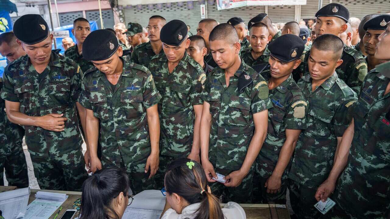 Members of the Thai military registering at a polling station before casting their ballots. 