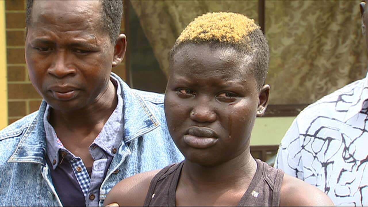 Roza Mawen’s daughter Krozina Ken cries as she remembers her mother.