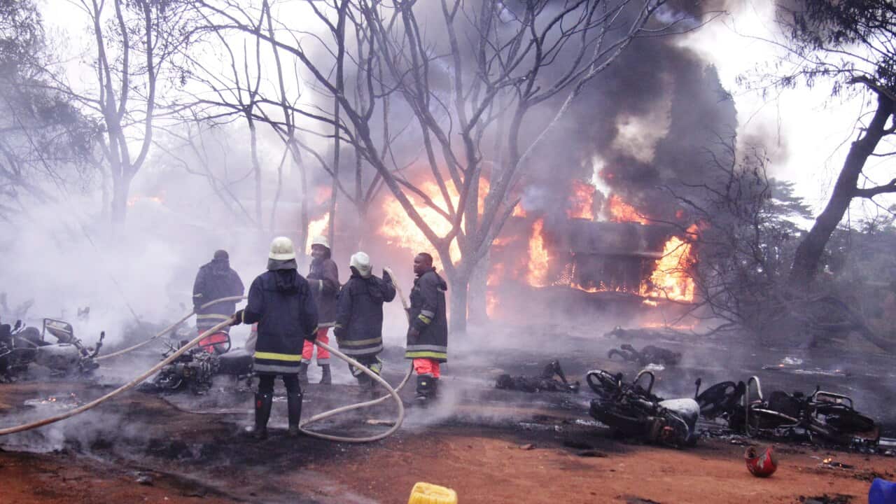 Fire fighters try to put off fire of the patrol tanker, in Tanzania