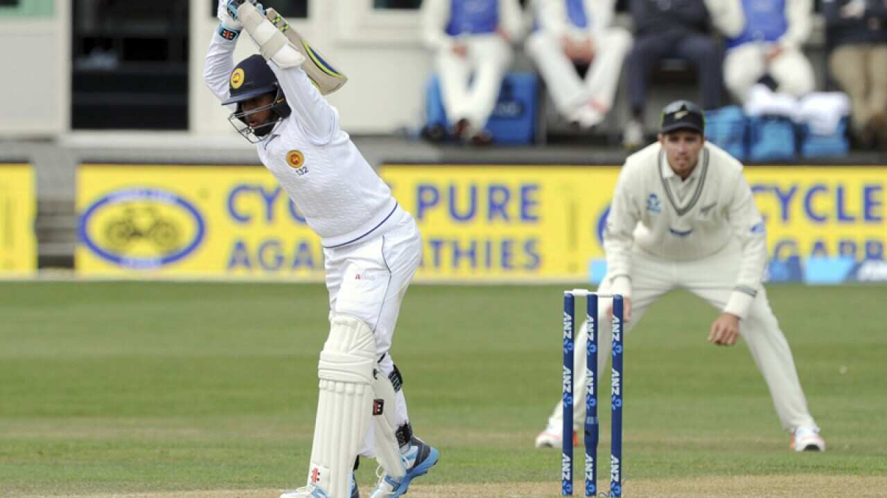 Sri Lanka’s Kusal Mendis (L) lets the ball pass against New Zealand