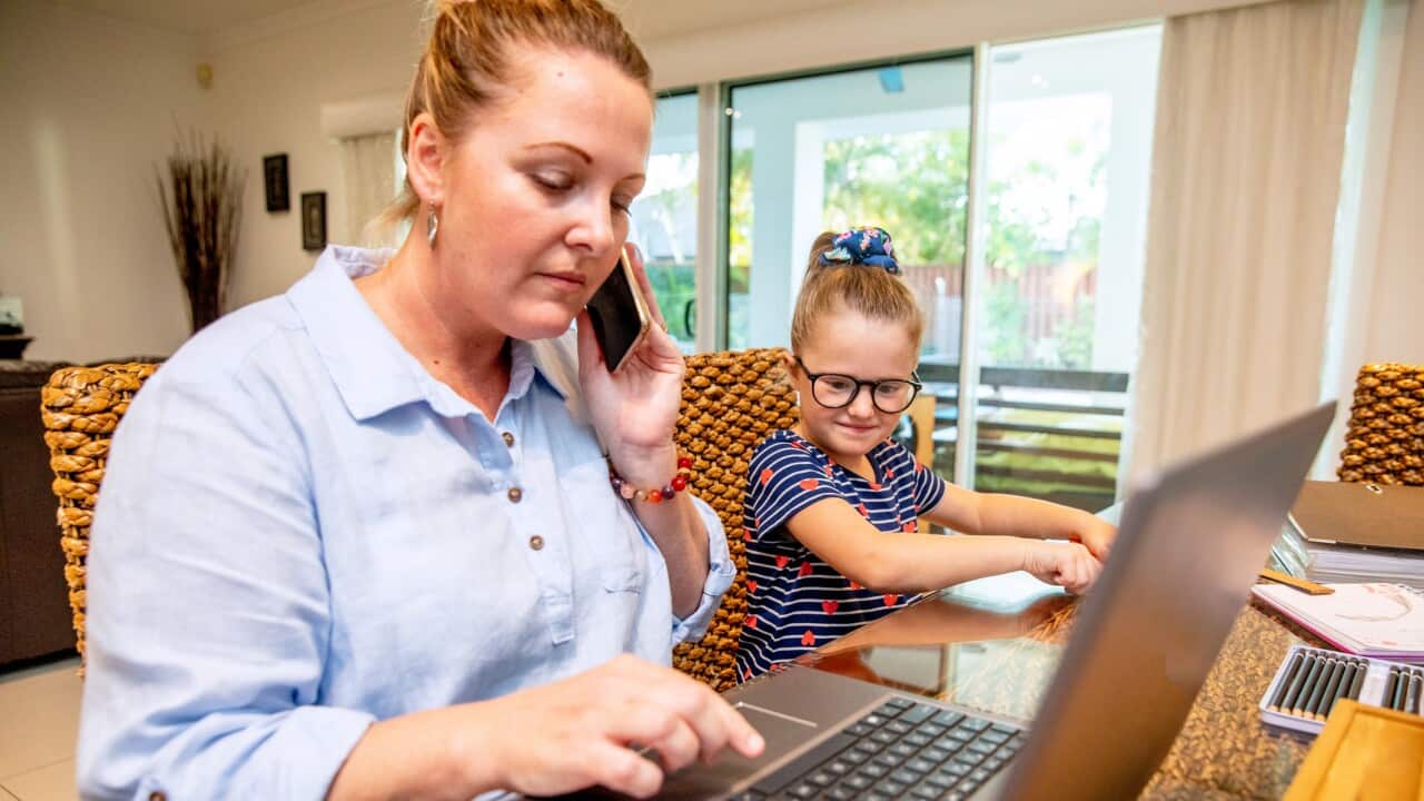 Parents working from home helping young children with school work
