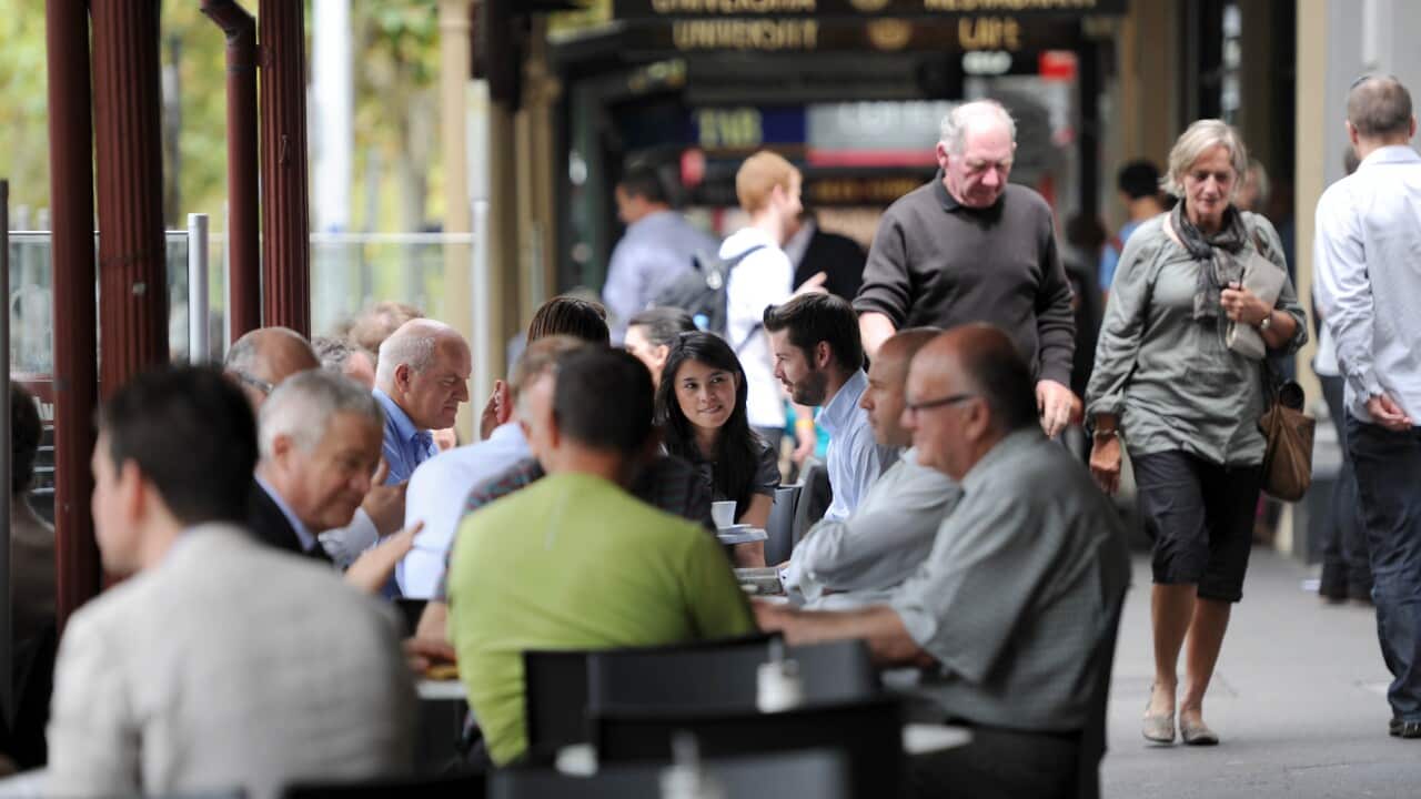 On the footpath outside cafes in Lygon Street, Melbourne.