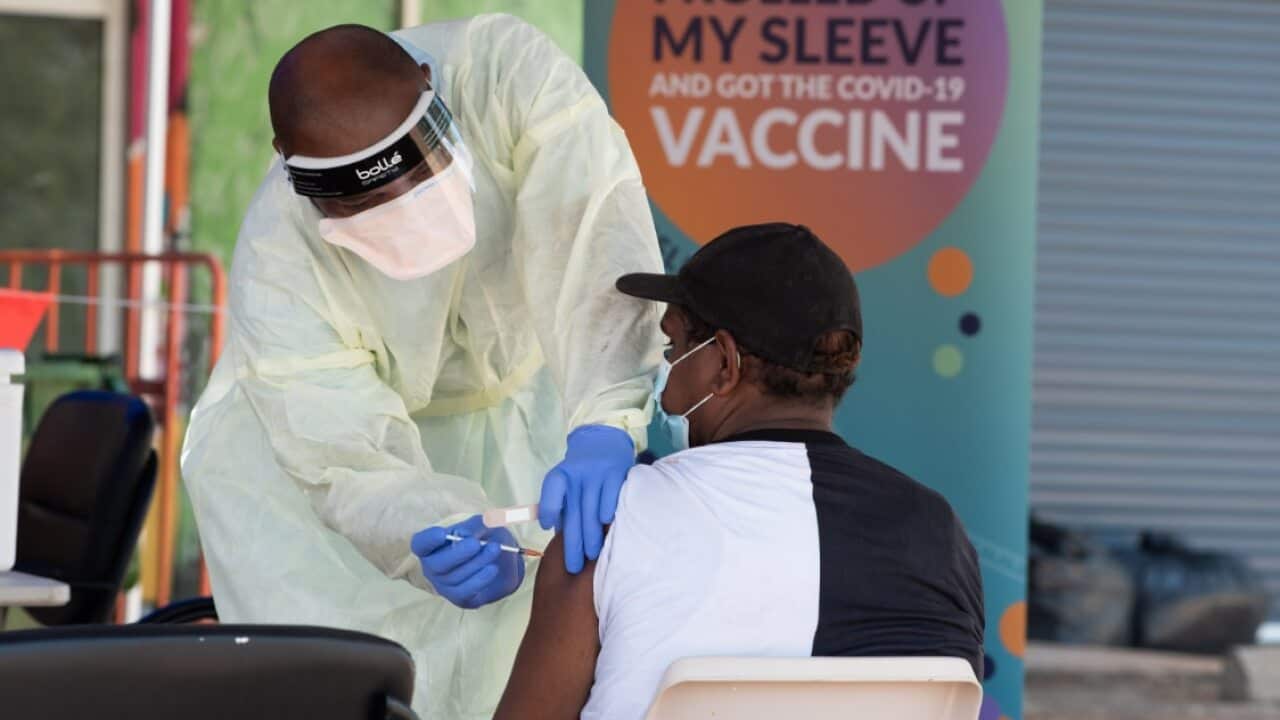 A health worker performs a vaccination at the Eastside walk in COVID-19 clinic, Katherine, Northern Territory.