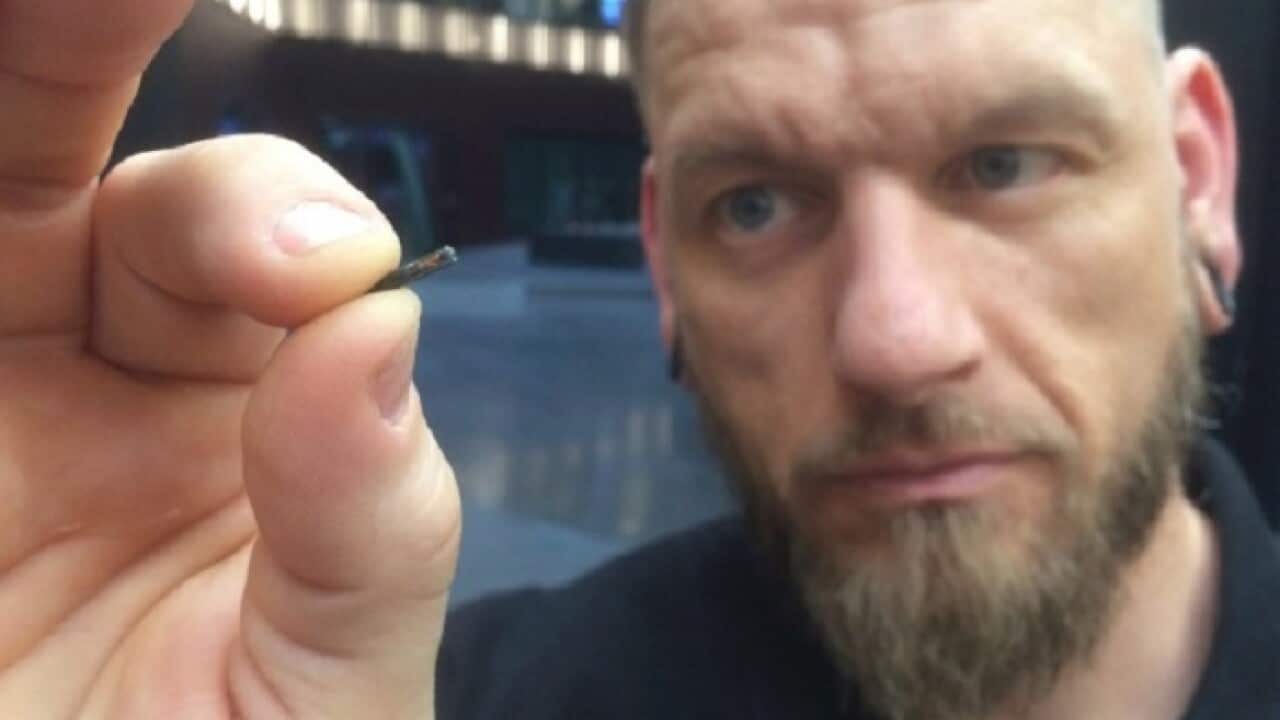 Self-described “body hacker” Jowan Osterlund, of Biohax Sweden, holds a microchip device similar to those implanted in workers at the Epicenter digital innovation business centre.