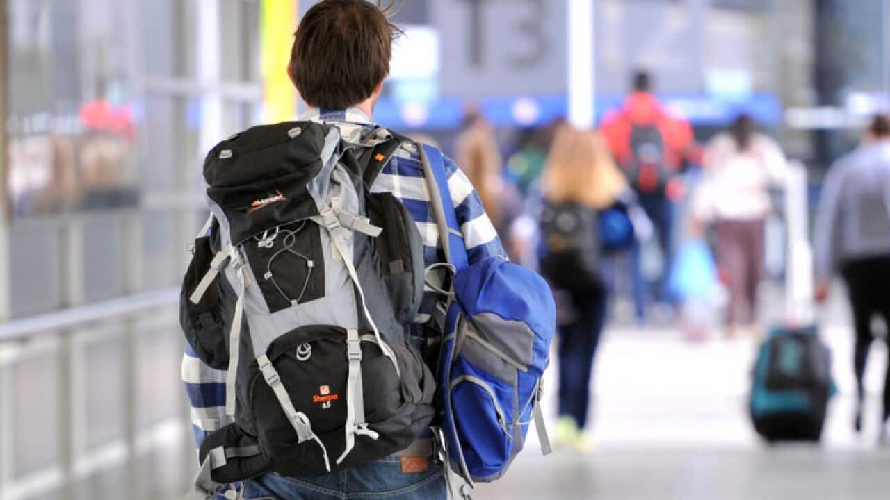 A backpacker makes his way to the international terminal at Melbourne Airport