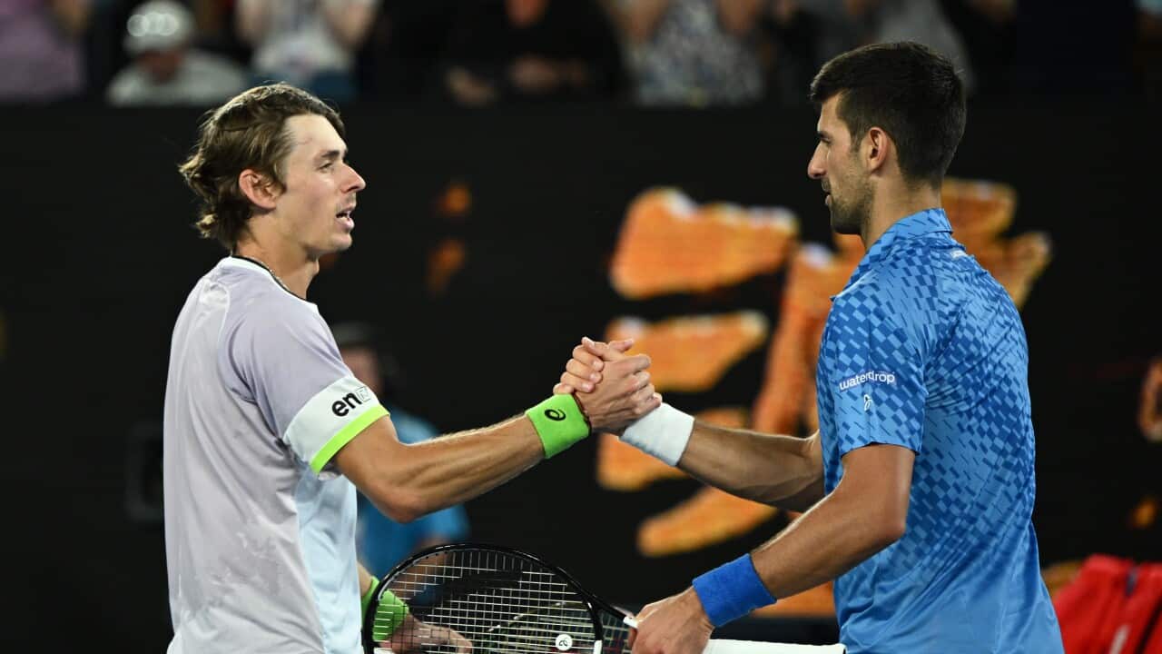 Two tennis players shake hands after a match.