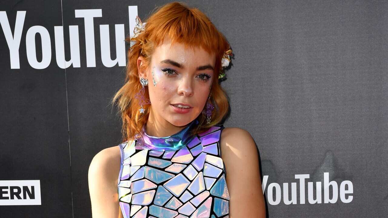 An actor posing on the red carpet.