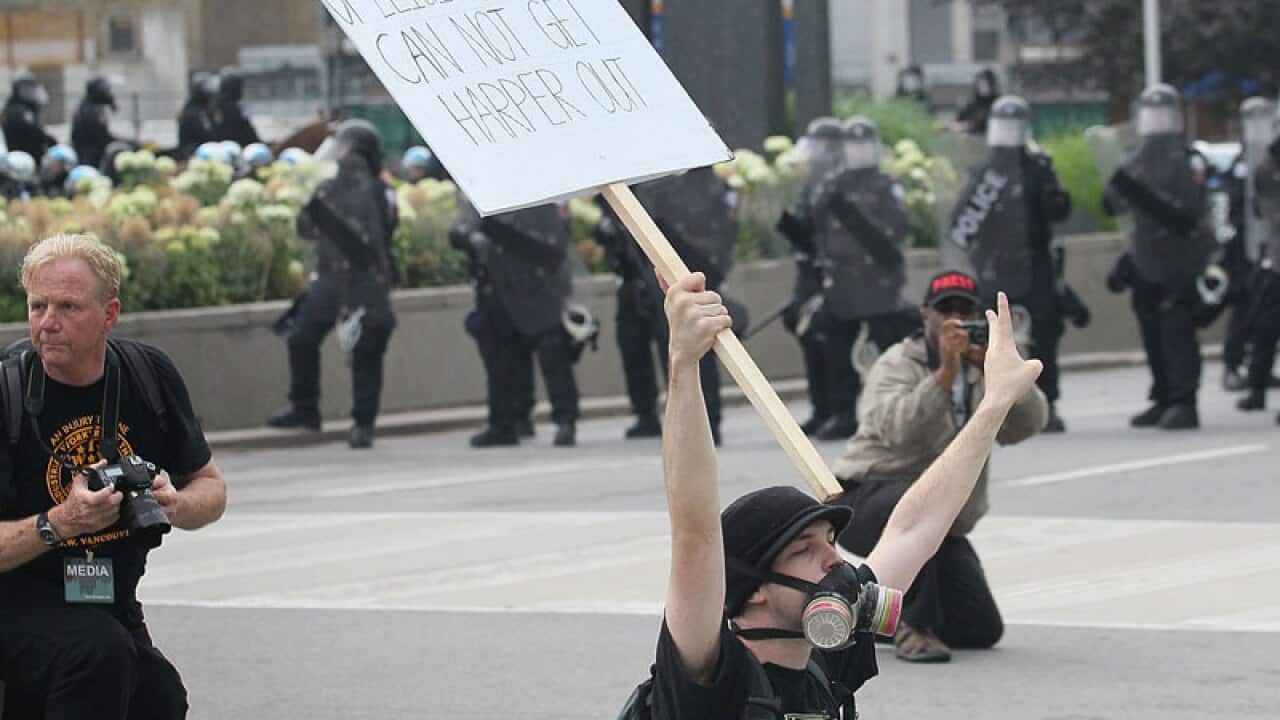 A demonstrator confronts police at the G20 protests in Toronto. (Getty)