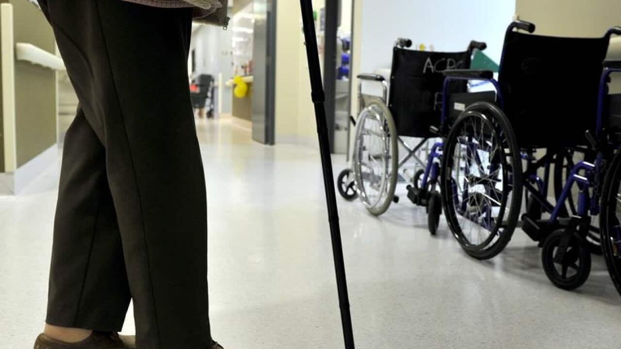 A file image of a woman using a walking stick