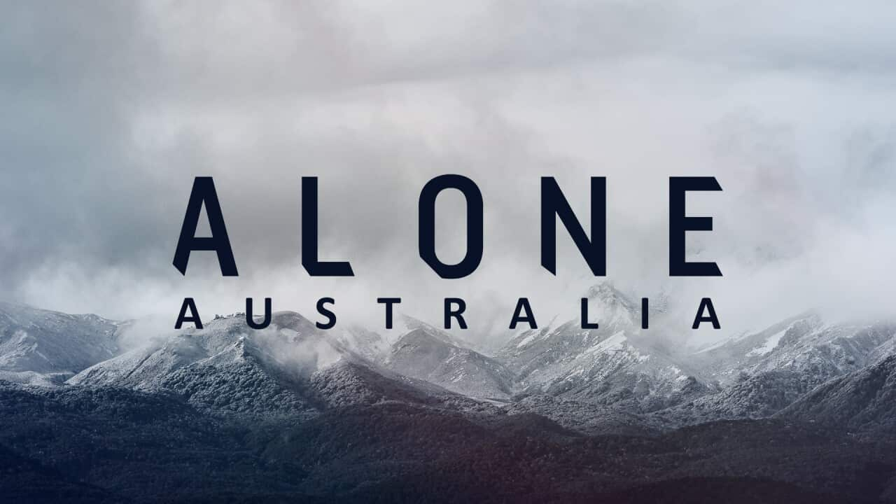 Snow covered mountains with Alone Australia text written on top