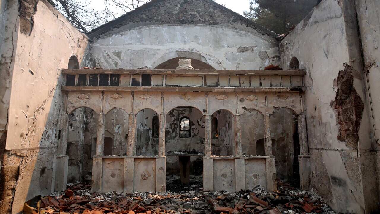 A view of the interior of a burnt church after a wildfire at Aetohori village, near the city of Alexandroupolis, Thrace, northern Greece, 20 August 2023. The wildfire that broke out early on 19 August in a forest in the Melia area of Alexandroupolis has spread rapidly due to the strong winds blowing in the area and is raging uncontrolled. Houses have been burned in the villages of Aetohori and Pefka as well as a church in Aetohori