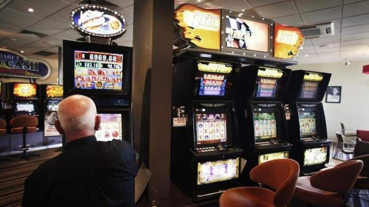 A man plays a pokie machine at a club in Altona, Victoria, Tuesday, Jan. 24, 2012. (AAP Image/Paul Jeffers)