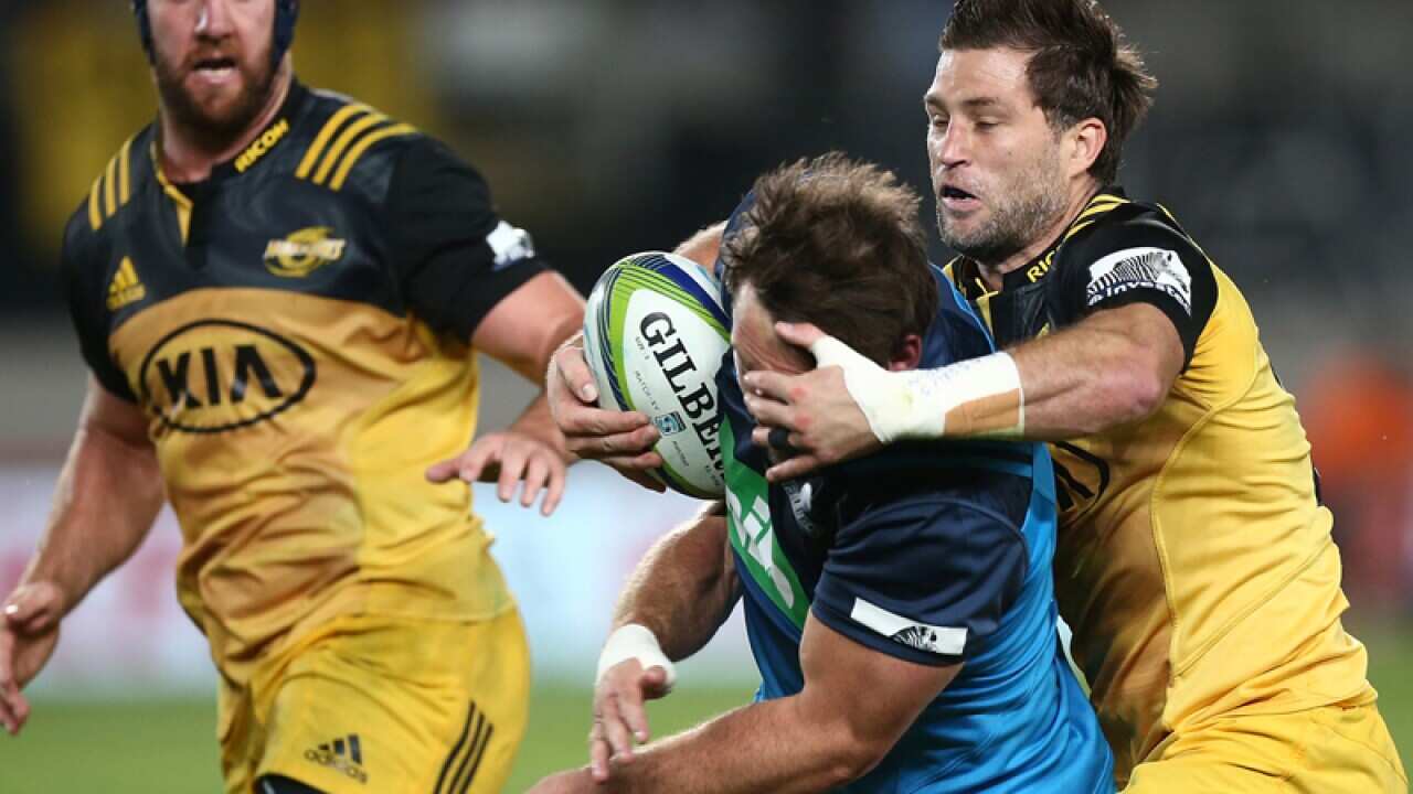 Cory Jane of the Hurricanes tackles Matt Moulds of the Blues