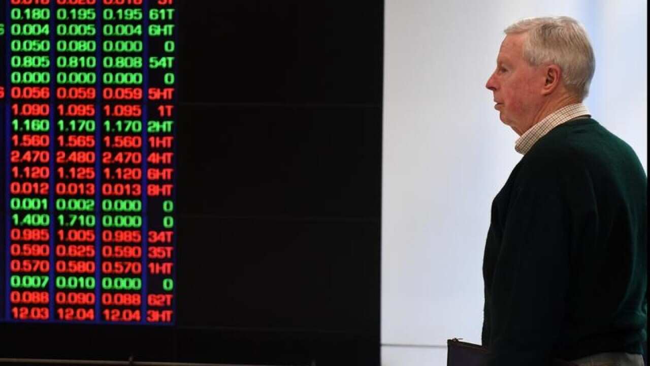 man standing by ASX information board