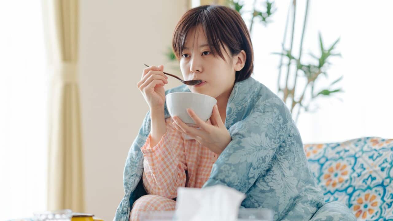 Woman eating soup