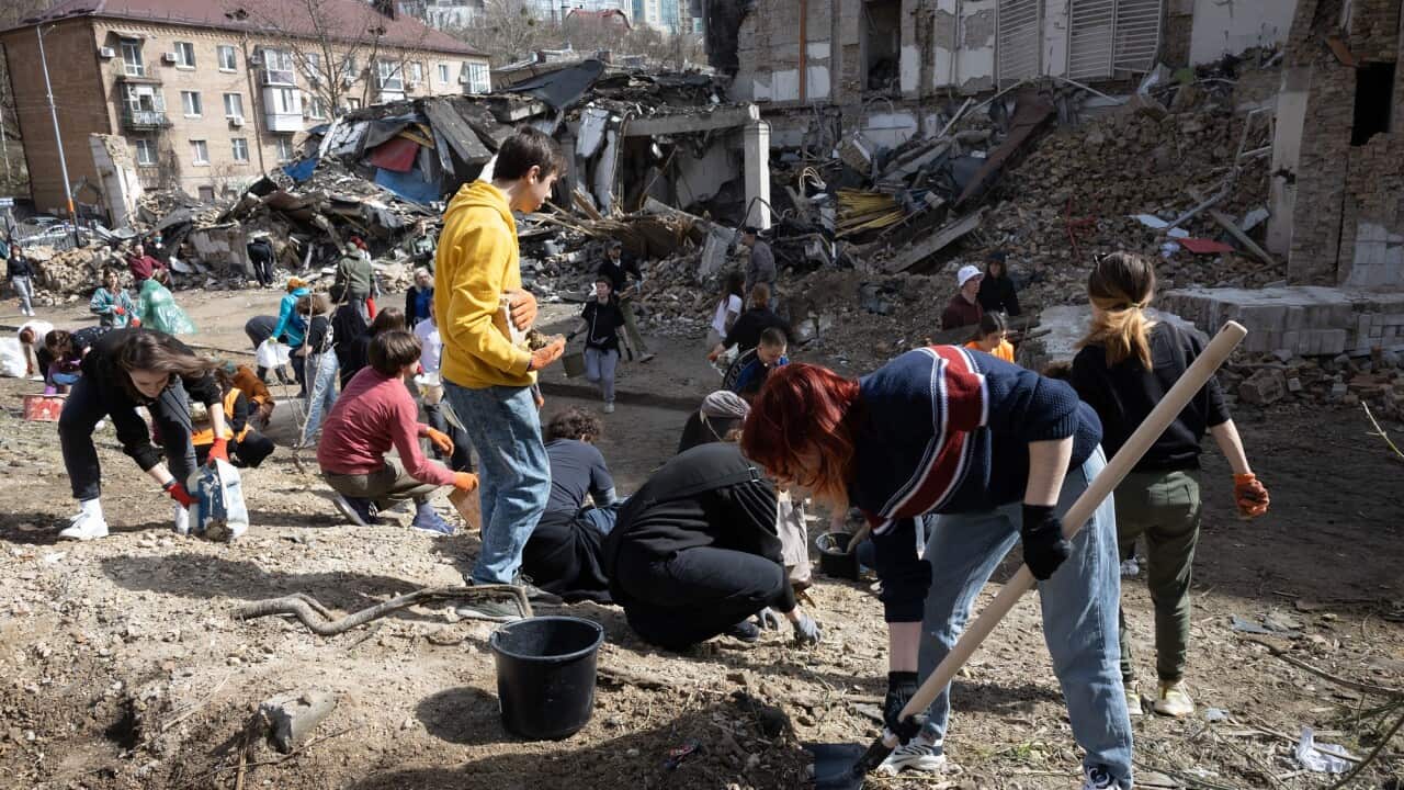 Students clean debris from Kyiv academy damaged by Russian shelling in Ukraine.