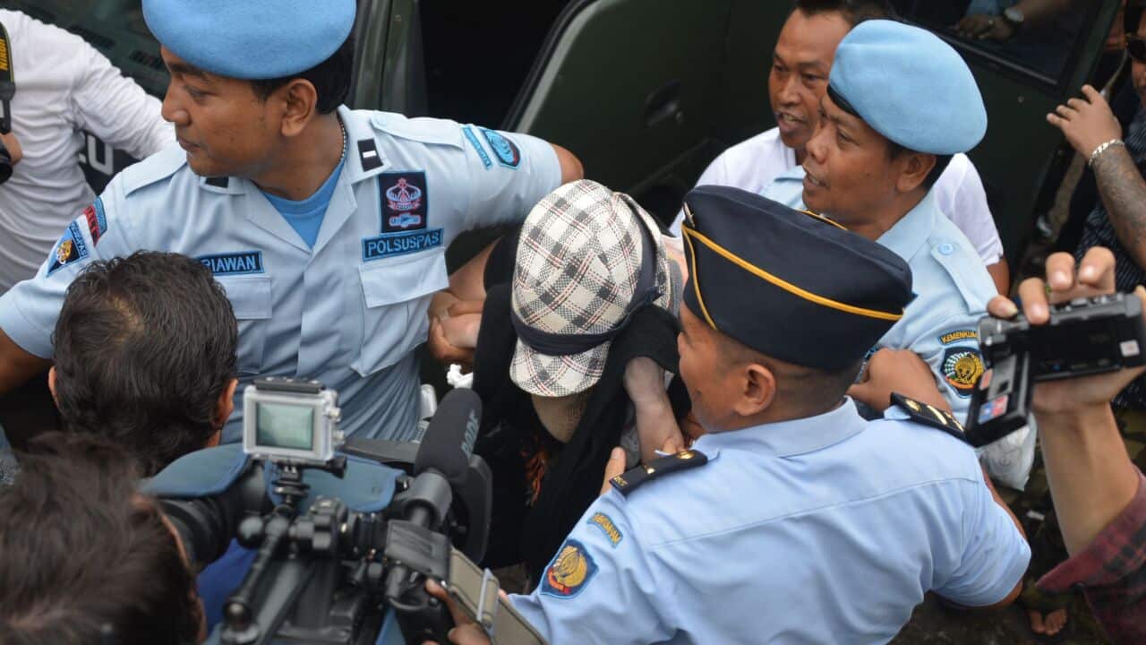 Schapelle Corby is escorted by police and prison officials - AAP-1.jpg