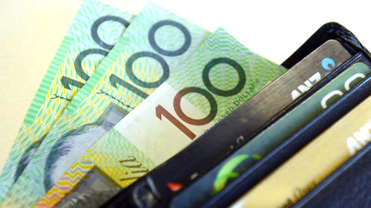 $100 Australian dollar notes pop out of a wallet with credit cards, pictured in Brisbane, Tuesday, Aug. 20, 2013. (AAP Image/Dan Peled) NO ARCHIVING