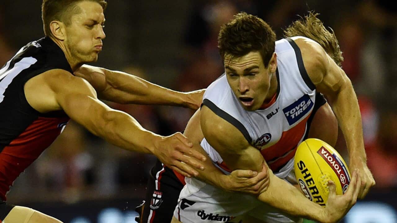 Jeremy Cameron of the Giants is tackled by Josh Bruce of the Saints