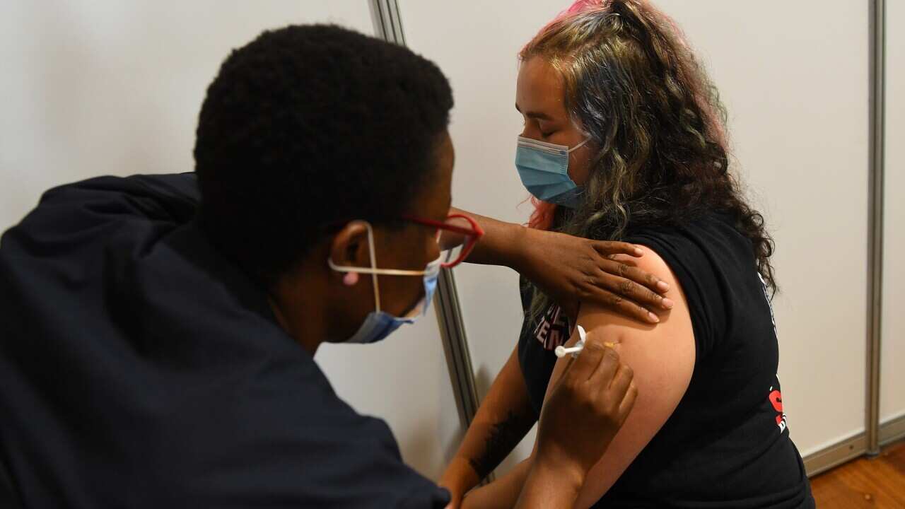 Paramedic Rhiannon Gallatly receives an AstraZeneca COVID-19 vaccination in Melbourne