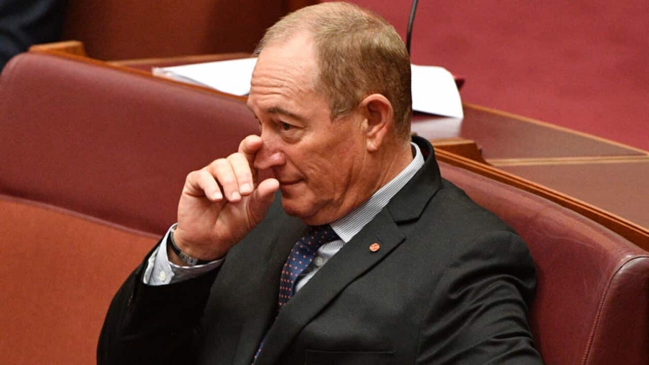 Senator Fraser Anning listens to a Greens censure motion