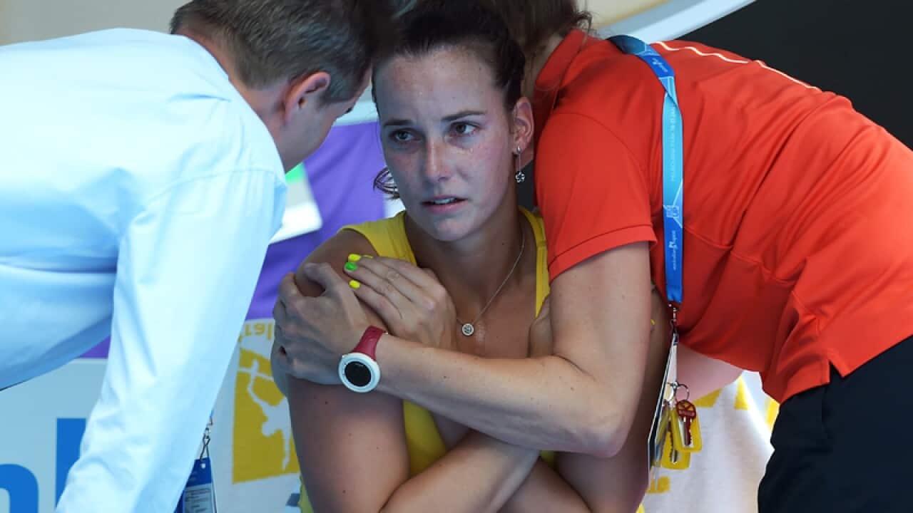 Jarmila Wolfe of Australia is embraced during a break in play