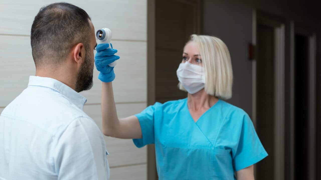Female doctor checking temperature