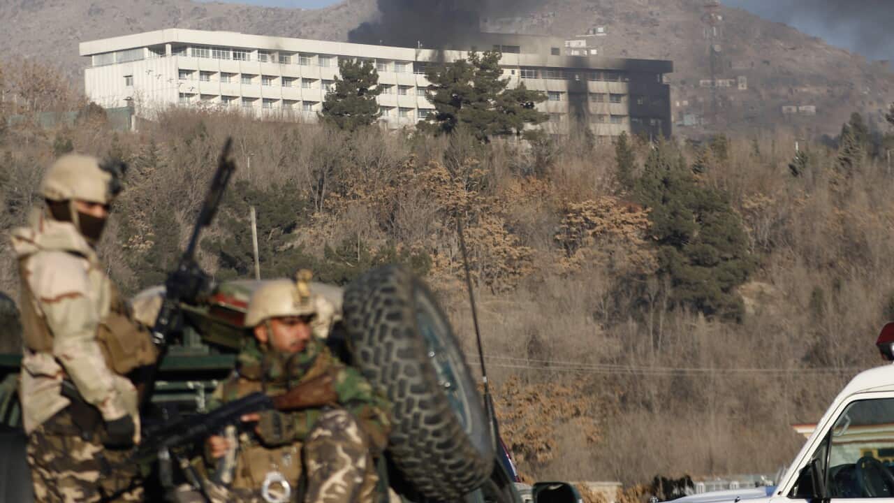 Smoke billows from the InterContinental hotel after an attack by armed gunmen in Kabul.