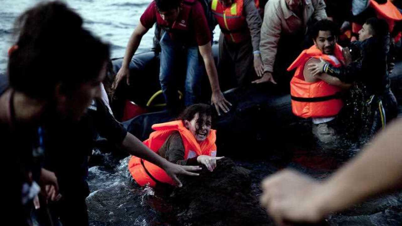 Syrian refugees arrive aboard a dinghy after crossing from Turkey, to the island of Lesbos, Greece, on Sunday, Sept. 20, 2015. Greece's coast guard was searching Sunday for 26 migrants missing off the coast of the eastern Aegean island of Lesbos after the