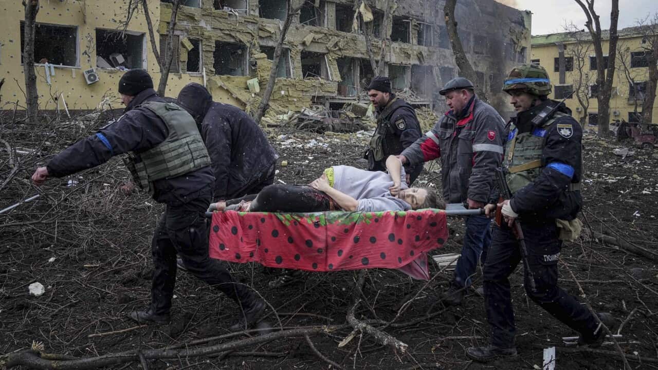 An injured pregnant woman is carried from a maternity hospital that was damaged by shelling in Mariupol, Ukraine.