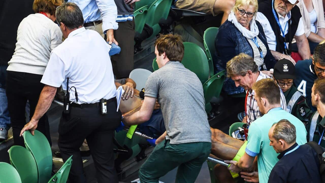 Officials and paramedics carry Nigel Sears on a stretcher.