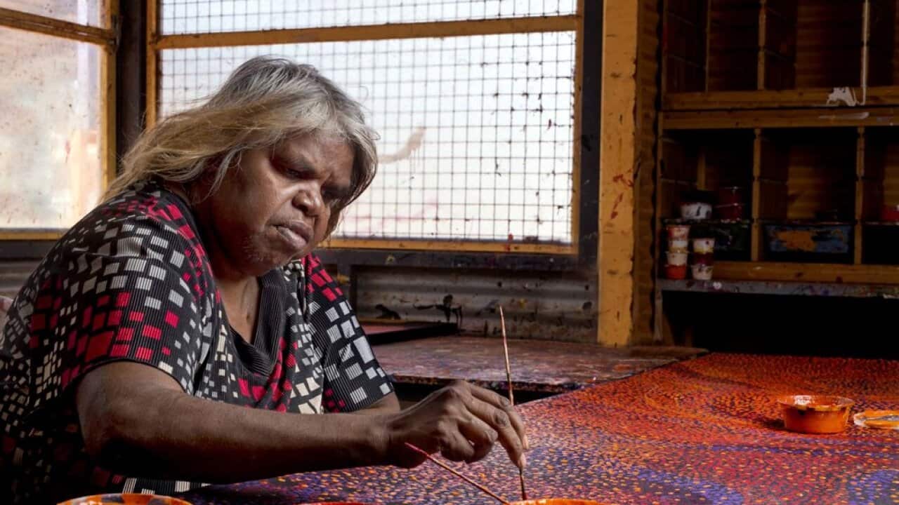 Nyunmiti Burton paints at the Tjala Arts Centre.