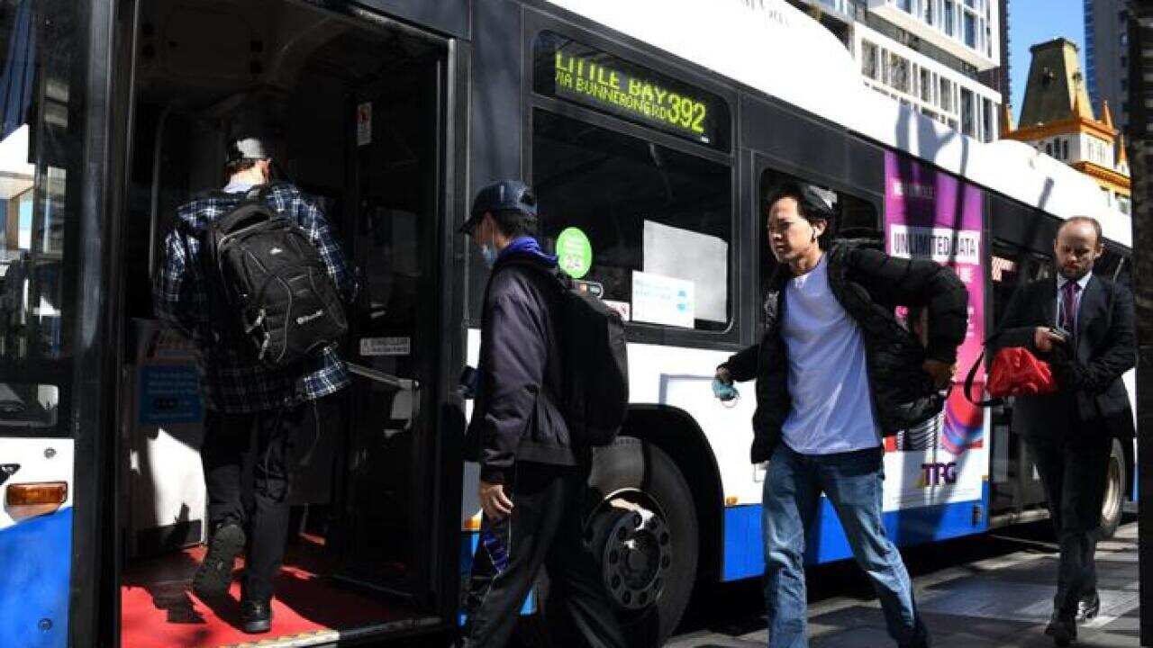 Commuters are seen boarding a bus in Sydney