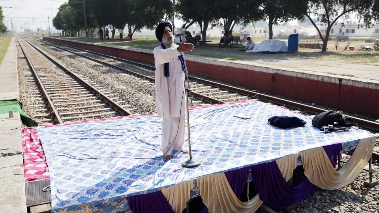 A farmer addresses a rally of protestors at a railway track in Jandiala, Punjab. 