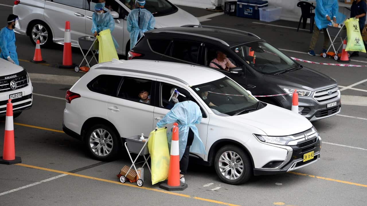 Cars queue as people wait to recieve a Covid test at a drive through testing facility at Sydney International Aiport, in Sydney, Wednesday, December 22, 2021. (AAP Image/Dan Himbrechts) NO ARCHIVING