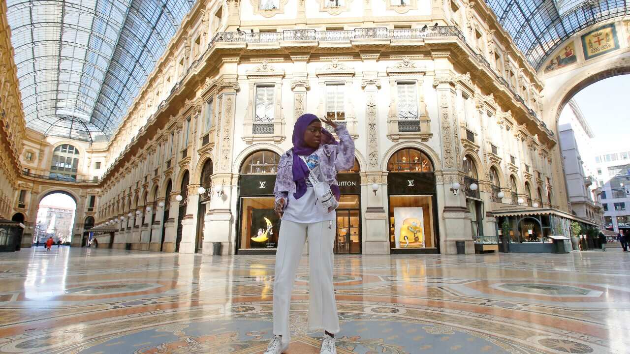 Aida Diouf Mbengue records a video for her TikTok account to share with her 330,000 followers in an empty Vittorio Emanuele gallery, Italy.