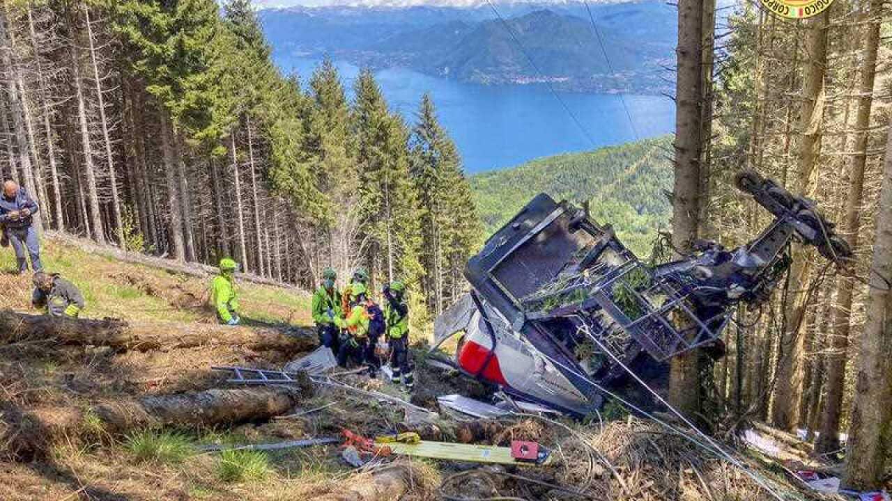 Rescuers work by the wreckage of a cable car after it collapsed near the summit of the Stresa-Mottarone line in northern Italy on 23 May 2021.