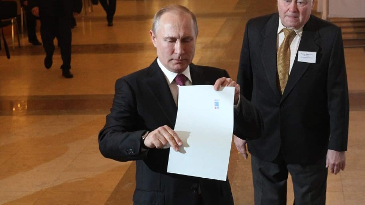 Russian President Vladimir Putin votes at a polling station in Moscow.