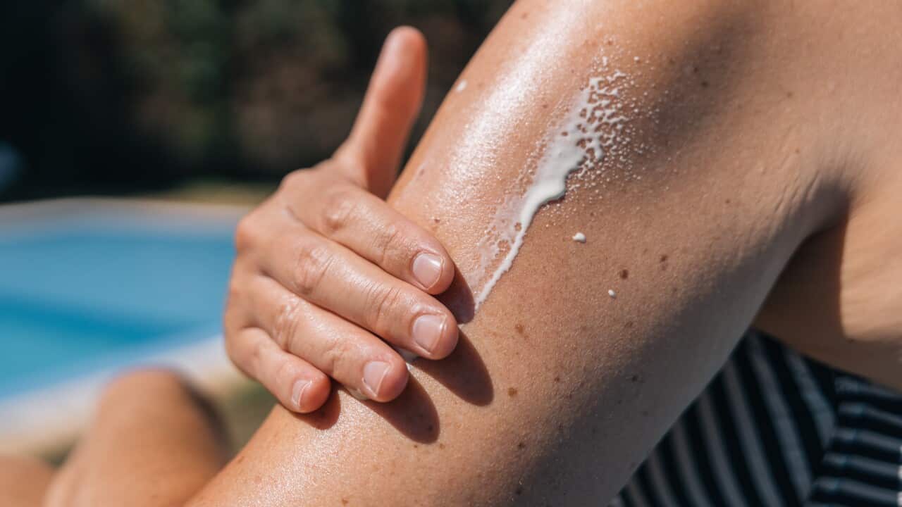 Close-up of a woman's hand applying sunscreen