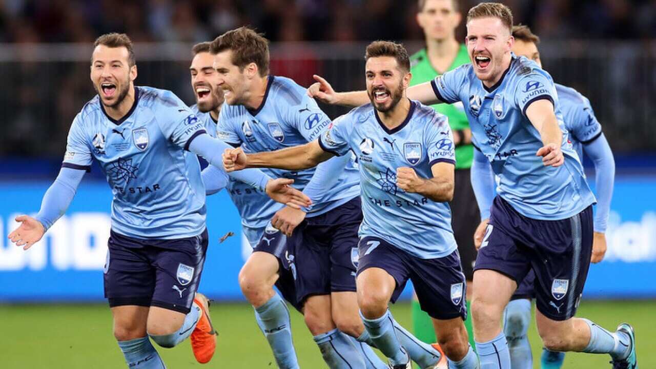 Sydney FC players celebrate winning the A-League title