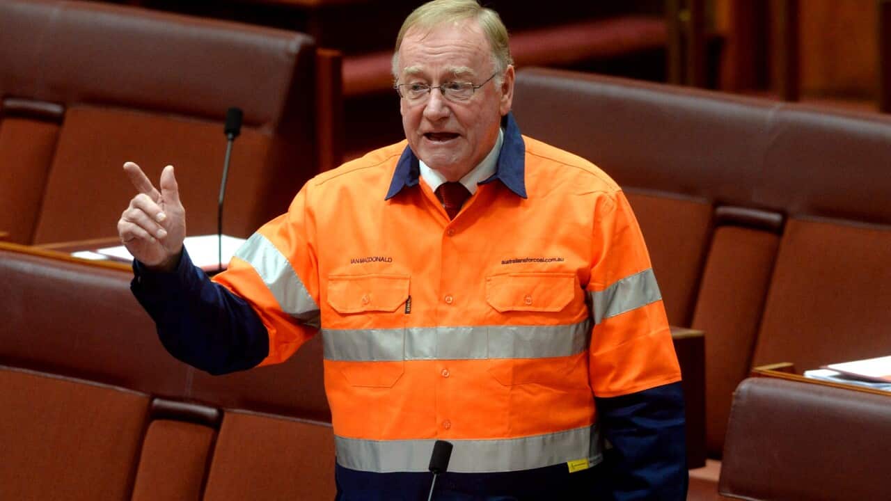 Senator Ian Macdonald (LNP QLD) wears a safety miners shirt supplied by the coal industry during the Mineral Resource Rent tax debate in the senate chamber at Parliament House Canberra.