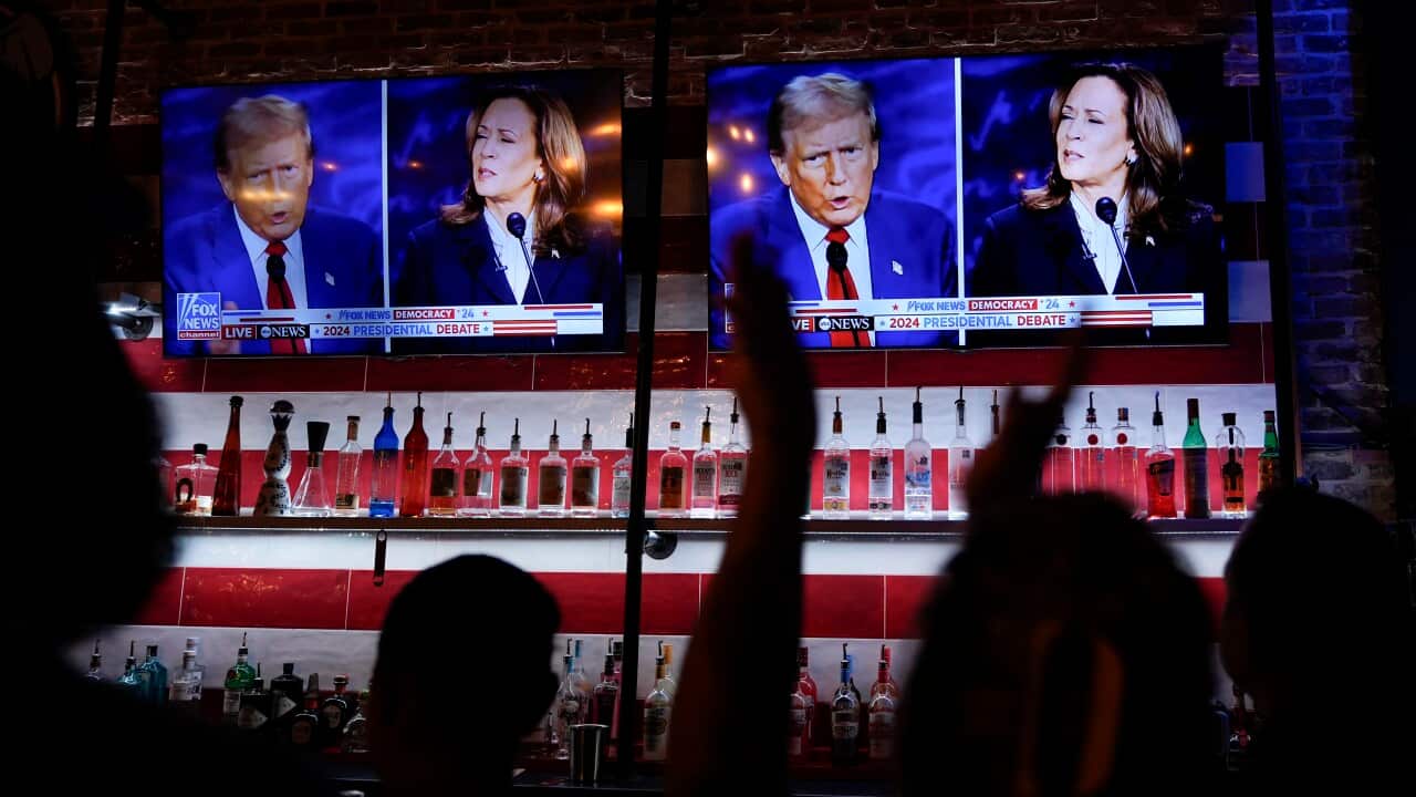People at a bar watching the US presidential debate between Donald Trump and Kamala Harris.