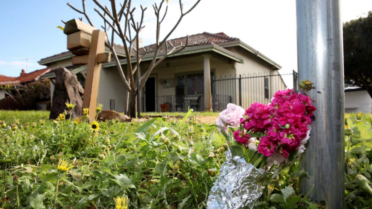 Flowers outside a house in Perth where five bodies were found.