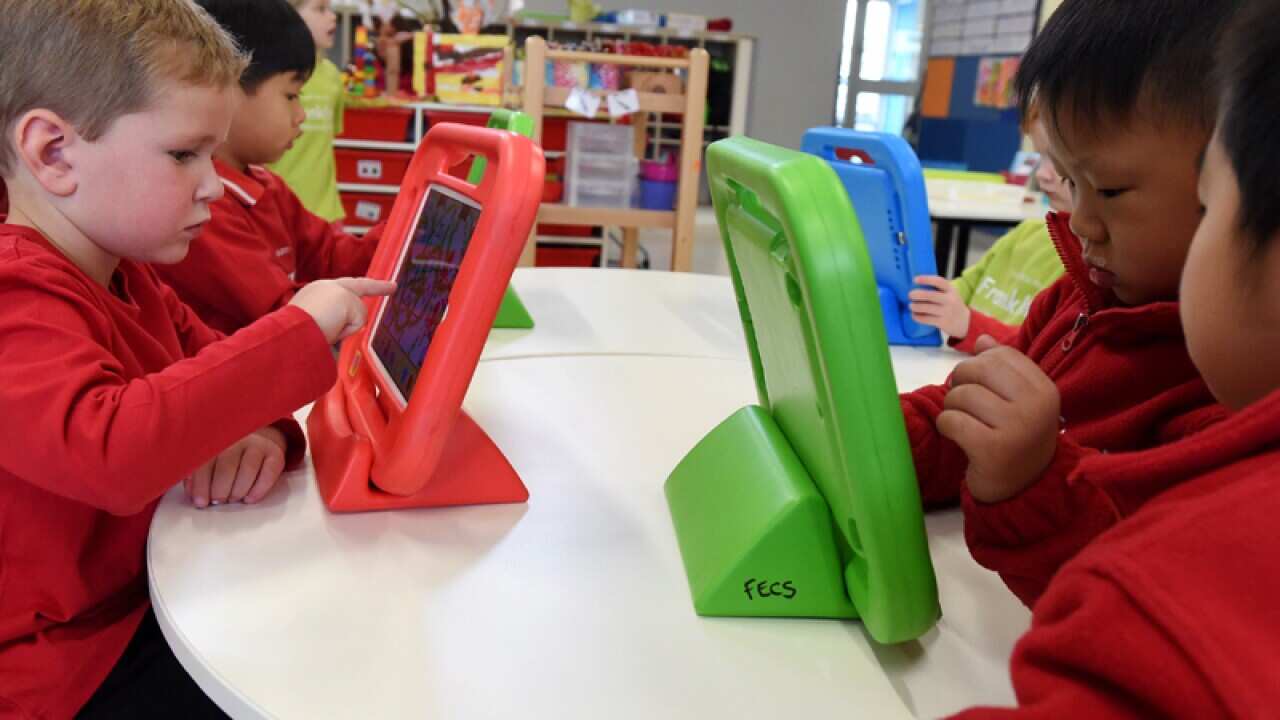 Kids play on iPads at Franklin Early Learning School in Canberra
