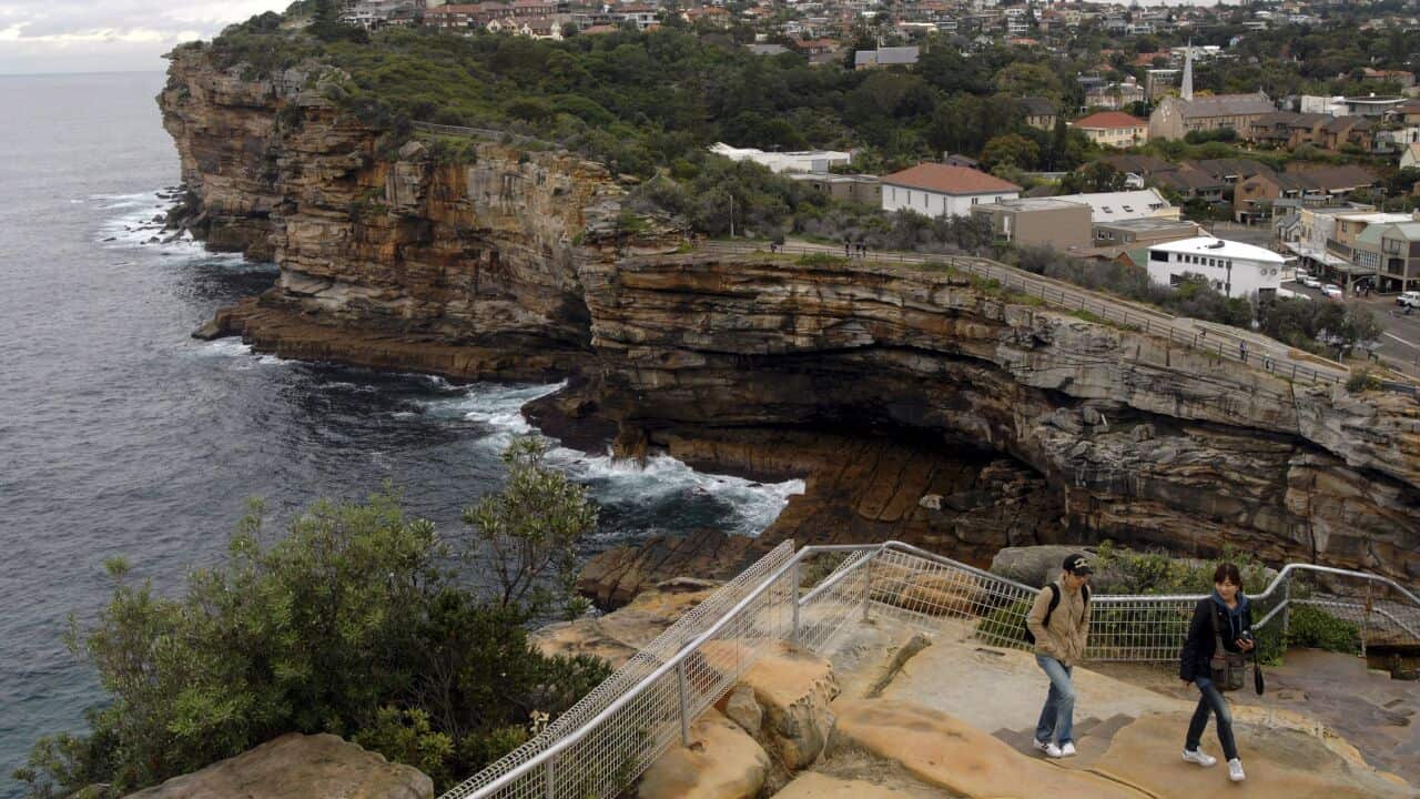 File photo: In this photo taken May 25, 2010, visitors walk around a notorious suicide spot called The Gap in Sydney, Australia. For almost 50 years Don Ritchie, widely regarded as a guardian angel, has used simple kindness to shepherd countless suicidal 
