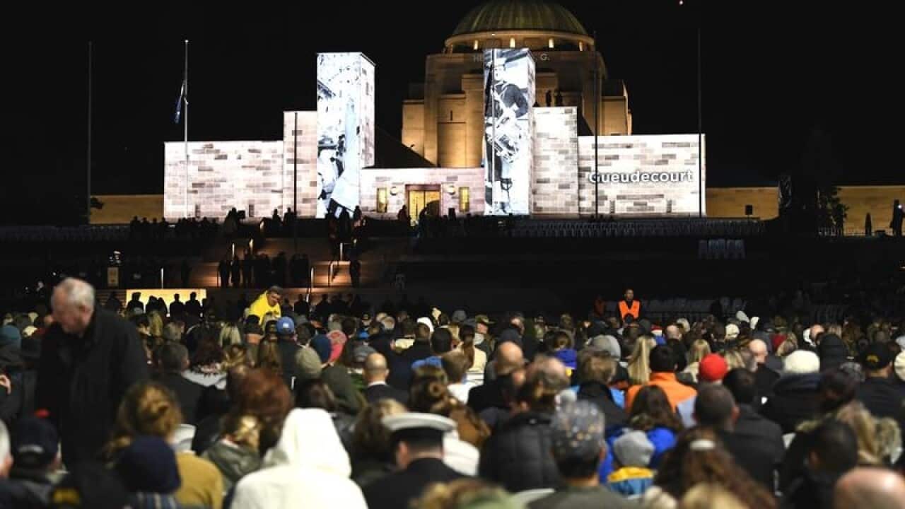 A crowd is seen outside at the National War Memorial in Canberra.