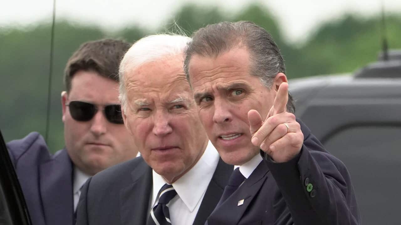 President Joe Biden talks with his son Hunter Biden as he arrives at Delaware Air National Guard Base.