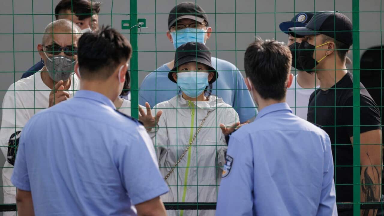 People argue with police behind quarantine fence during the protest, amid new round of COVID-19 lockdowns, in Shanghai, China, 06 June 2022