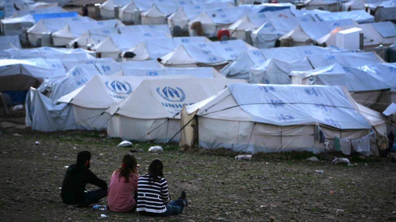 Kurdish Syrian refugees sit and look on at the Quru Gusik refugee camp in Iraq - AAP-1.jpg